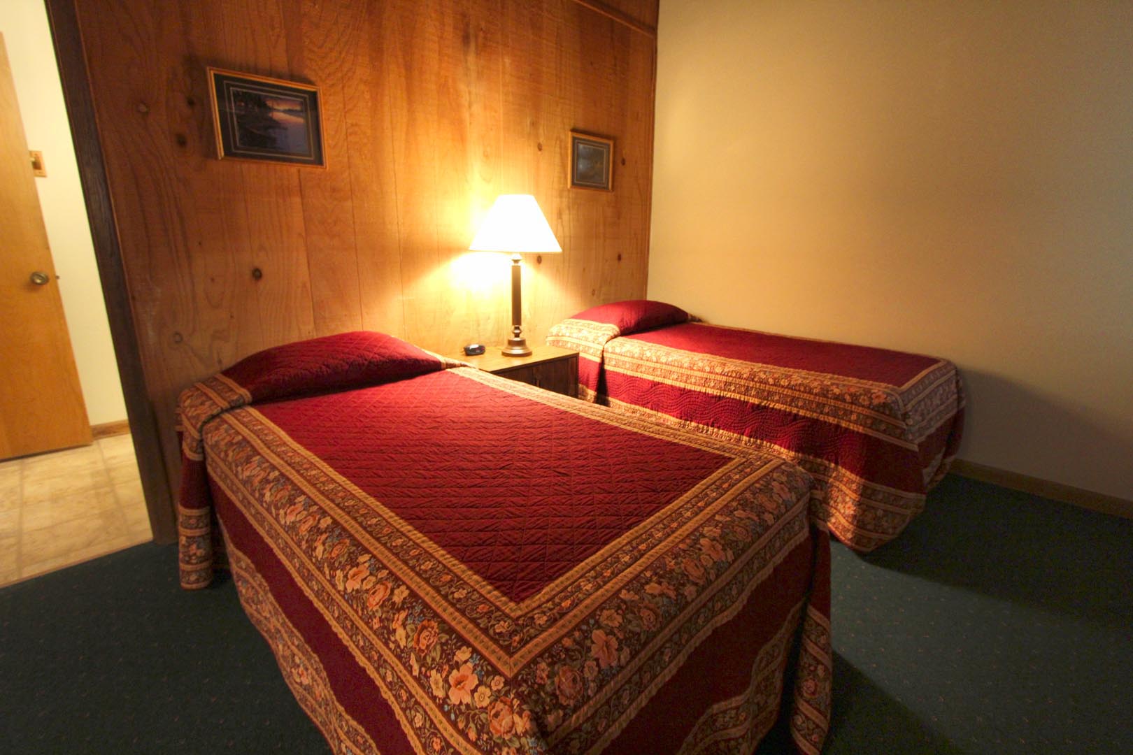 A bedroom with double beds at VRI's Golf Club Villas in Marble Hill, Georgia.